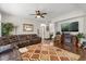 Comfortable living area with hardwood floors, entertainment center, and natural lighting at 1704 Pine Ridge Dr, Davenport, FL 33896