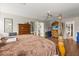 Large main bedroom featuring hardwood floors, wooden bed frame, and dresser with TV at 1704 Pine Ridge Dr, Davenport, FL 33896