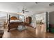 Expansive main bedroom featuring hardwood floors, wooden bed frame and a door opening to another room at 1704 Pine Ridge Dr, Davenport, FL 33896