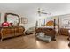 Spacious main bedroom features wood floors, large bed with dresser and bedside tables at 1704 Pine Ridge Dr, Davenport, FL 33896