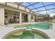 Screened-in pool and hot tub area with outdoor seating; a perfect spot for relaxation and entertaining at 1704 Pine Ridge Dr, Davenport, FL 33896