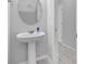 Bathroom featuring pedestal sink, mirror and neutral tiling at 178 Aberdeen St, Davenport, FL 33896