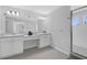 Bathroom featuring dual sinks, a walk-in shower, and ample counter space at 178 Aberdeen St, Davenport, FL 33896