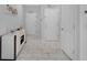 Clean entryway with bright floors and minimalist decor offering a welcoming and modern aesthetic at 178 Aberdeen St, Davenport, FL 33896
