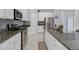 Bright kitchen with granite countertops, modern appliances and white cabinetry offering a clean and stylish design at 178 Aberdeen St, Davenport, FL 33896