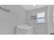 Bright laundry room with machines, storage and a window at 178 Aberdeen St, Davenport, FL 33896