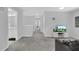 Cozy living area with neutral carpet, modern TV stand and comfortable seating perfect for relaxation and entertainment at 178 Aberdeen St, Davenport, FL 33896