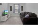 Comfortable living room with neutral carpet, TV, and cozy sofa, ideal for relaxed living and entertainment at 178 Aberdeen St, Davenport, FL 33896