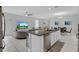 Open-concept living room with large island, sleek appliances, and dining area perfect for modern living and entertaining at 178 Aberdeen St, Davenport, FL 33896