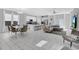 Open-concept living space with dining area, modern kitchen, and comfortable seating arrangements at 178 Aberdeen St, Davenport, FL 33896