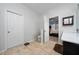 Neutral bathroom with tile floors, commode, and adjoining bedroom at 205 Lakeshore Dr, Davenport, FL 33837