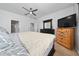 Cozy bedroom featuring ceiling fan, neutral walls, and wood furnishings at 205 Lakeshore Dr, Davenport, FL 33837