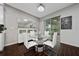 Contemporary dining area with a glass table, white chairs, and modern lighting at 205 Lakeshore Dr, Davenport, FL 33837