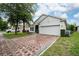 Charming single-story home with a brick driveway and well-maintained landscaping at 205 Lakeshore Dr, Davenport, FL 33837