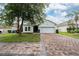 Charming single-story home features a brick driveway and lush green lawn at 205 Lakeshore Dr, Davenport, FL 33837