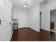 Inviting foyer with stylish dark wood flooring and bright, neutral walls at 205 Lakeshore Dr, Davenport, FL 33837