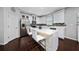 Modern kitchen with white cabinetry, stainless steel appliances, and an island with seating at 205 Lakeshore Dr, Davenport, FL 33837