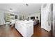 Open-concept kitchen featuring a white island, stainless steel appliances, and access to the living area at 205 Lakeshore Dr, Davenport, FL 33837