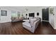 Elegant living room boasts dark floors, comfortable grey sofas, and a modern entertainment center at 205 Lakeshore Dr, Davenport, FL 33837