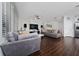 Spacious living room with dark wood floors, comfortable seating, and natural light at 205 Lakeshore Dr, Davenport, FL 33837