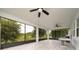 Spacious screened porch with multiple ceiling fans overlooking lush greenery at 205 Lakeshore Dr, Davenport, FL 33837