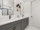 Modern bathroom featuring double sinks, sleek gray cabinetry, and stylish lighting fixtures at 2108 Celebration Blvd, Celebration, FL 34747