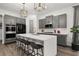 Modern kitchen features gray cabinets, a large island with seating, and stainless steel appliances at 2108 Celebration Blvd, Celebration, FL 34747