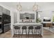 Modern kitchen with a center island, bar stool seating, grey cabinets, and stainless steel appliances at 2108 Celebration Blvd, Celebration, FL 34747