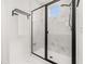 Luxurious shower with a sleek black frame and elegant marble-look tile at 2108 Celebration Blvd, Celebration, FL 34747