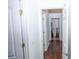 Hallway featuring hardwood floors and white doors, leading to other rooms in the house at 2268 Victoria Falls Dr, Orlando, FL 32824
