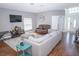 Spacious living area with hardwood floors, neutral walls, and a seating arrangement, with white sofa at 2268 Victoria Falls Dr, Orlando, FL 32824