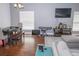 Open-concept living room showcasing hardwood floors, a dining table, and a cozy gray sofa with area rug at 2268 Victoria Falls Dr, Orlando, FL 32824