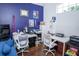 Home office with hardwood floors, blue accent wall, two desks, and a window providing natural light at 2268 Victoria Falls Dr, Orlando, FL 32824