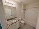 Well-lit bathroom featuring a granite vanity, tiled floors, a shower and tub combination at 2479 White Lilly Dr, Kissimmee, FL 34747