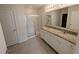 Bathroom featuring granite countertops, double sinks, tiled flooring, and a glass shower enclosure at 2479 White Lilly Dr, Kissimmee, FL 34747