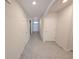Bright hallway with tile floors, leading to various rooms in the house and an entry door at 2479 White Lilly Dr, Kissimmee, FL 34747