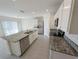 Open kitchen featuring an island with granite countertops, stainless steel appliances, and modern lighting at 2479 White Lilly Dr, Kissimmee, FL 34747