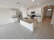 Spacious kitchen with an island, granite countertops, stainless steel appliances, and white cabinetry at 2479 White Lilly Dr, Kissimmee, FL 34747