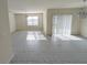 Bright living room with tile floors and a sliding glass door and a window at 2479 White Lilly Dr, Kissimmee, FL 34747