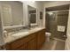 Bathroom features a double sink vanity with granite countertop and enclosed shower at 2646 Quarterdeck Ct, Kissimmee, FL 34743
