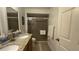 Bathroom features a double sink vanity with granite countertop and enclosed shower at 2646 Quarterdeck Ct, Kissimmee, FL 34743