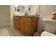 Bathroom features a double sink vanity with granite countertop and framed mirror at 2646 Quarterdeck Ct, Kissimmee, FL 34743