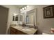 Bathroom features a double sink vanity with granite countertop and framed mirror at 2646 Quarterdeck Ct, Kissimmee, FL 34743