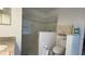 Bathroom featuring a glassed-in walk-in shower and toilet with storage at 2646 Quarterdeck Ct, Kissimmee, FL 34743
