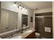Bathroom features a double sink vanity with granite countertop and enclosed shower at 2646 Quarterdeck Ct, Kissimmee, FL 34743