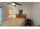 Bedroom with a ceiling fan, window and a patterned bedspread at 2646 Quarterdeck Ct, Kissimmee, FL 34743