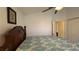 Bright bedroom with a comfortable bed and view into the hallway and closet at 2646 Quarterdeck Ct, Kissimmee, FL 34743