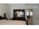Bedroom with queen-sized bed and dresser with mirror, with a view of the living room at 2646 Quarterdeck Ct, Kissimmee, FL 34743