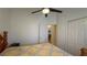 Bedroom with a ceiling fan and view of closet and attached bath at 2646 Quarterdeck Ct, Kissimmee, FL 34743