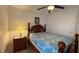 Cozy bedroom featuring tile floor, ceiling fan, and wooden furniture at 2646 Quarterdeck Ct, Kissimmee, FL 34743